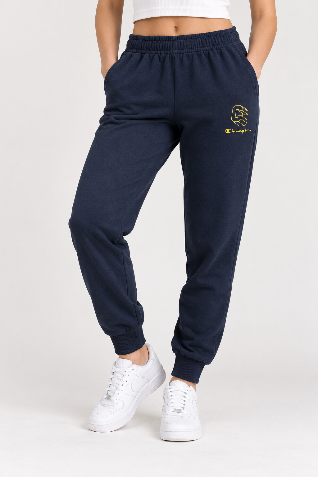 Foto ilustrativa en modelo del pantalón Champion azul marino, cintura abajo, formato 3:4